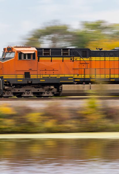train traveling on tracks next to a body of water