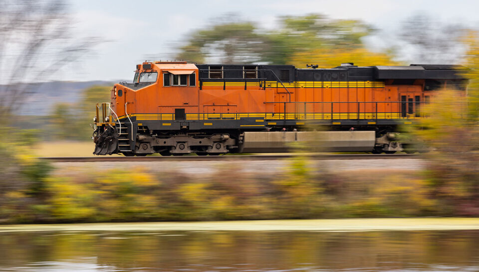 train traveling on tracks next to a body of water