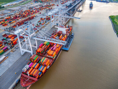 ship with containers being loaded at a port