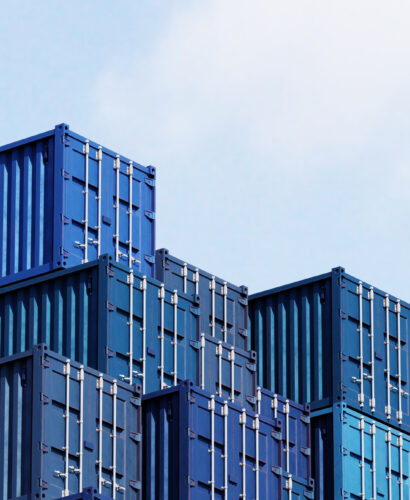 Stack of blue container boxes with sky background. Cargo freight shipping for import and export logistics. Business and transportation concept. 3D illustration rendering