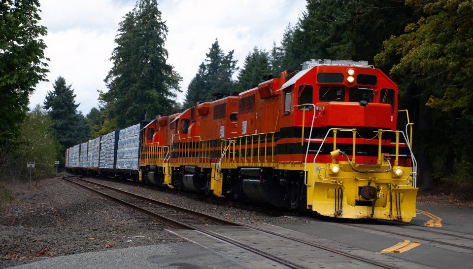 Train crossing rural road hauling cargo