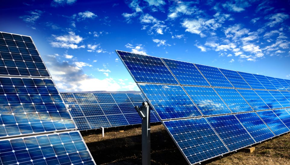 Photo voltaic solar panels and blue sky with clouds